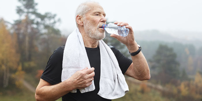 man drinking water after exercise